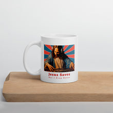 Load image into Gallery viewer, White mug with a graphic of a religious figure and text 'Jesus Saves but I Drop Beats' on a wooden surface.
