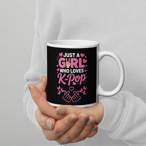 Mug with 'Just a Girl Who Loves K-Pop' text held by a person against a gray background
